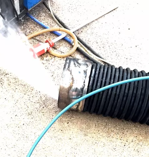 Old burst heating coil from Nilfisk Contractor pressure washer being pressure tested to find the leak.